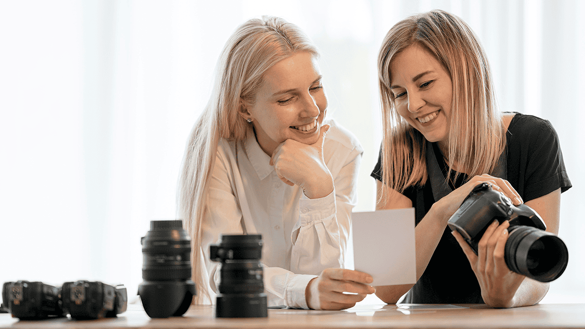 Svatební fotografka se snoubenkou diskutují svatební fotografie - ilustrační foto k článku Kolik stojí fotograf na svatbu
